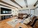 Inviting living room with decorative beams, tile floors, and comfortable seating arrangement perfect for relaxation at 213 Sheffield E Cir, Palm Harbor, FL 34683