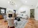 Comfortable living room with a brick fireplace, vaulted ceiling, and ample natural light at 213 Sheffield E Cir, Palm Harbor, FL 34683