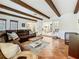 Comfortable living room with exposed beams, French doors, tile flooring, and view into the kitchen at 213 Sheffield E Cir, Palm Harbor, FL 34683