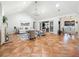 Bright living room features a vaulted ceiling, two seating areas and a fireplace at 213 Sheffield E Cir, Palm Harbor, FL 34683
