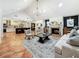 Spacious living room with fireplace and seamless flow to kitchen and dining area at 213 Sheffield E Cir, Palm Harbor, FL 34683