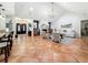 Expansive living room boasts a fireplace, bar area, and seamless transition to dining and kitchen at 213 Sheffield E Cir, Palm Harbor, FL 34683