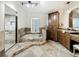 Beautiful main bathroom with granite counters, tub with jets, separate shower, and custom cabinetry at 213 Sheffield E Cir, Palm Harbor, FL 34683