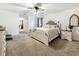 Comfortable main bedroom featuring neutral decor, plush carpet, and a window overlooking the backyard at 213 Sheffield E Cir, Palm Harbor, FL 34683
