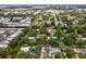 An overhead view shows this residence nestled in a serene neighborhood, surrounded by lush greenery and tree-lined streets at 232 Emerald Ln, Largo, FL 33771