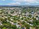 Picturesque neighborhood view features a canopy of trees, serene lakes, and proximity to urban amenities at 232 Emerald Ln, Largo, FL 33771