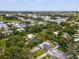 An overhead view shows this house situated in a peaceful, verdant neighborhood, complete with fenced backyard at 232 Emerald Ln, Largo, FL 33771