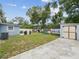Backyard featuring a shed, grill, playground, and grassy area at 232 Emerald Ln, Largo, FL 33771