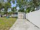 Backyard featuring a shed, grill, playground, and grassy area at 232 Emerald Ln, Largo, FL 33771