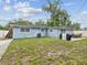Backyard featuring a grill, patio set, and grassy area at 232 Emerald Ln, Largo, FL 33771