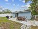 A spacious backyard featuring a patio set and grassy area at 232 Emerald Ln, Largo, FL 33771