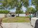 A spacious backyard with a grill, playground, shed, and grassy area at 232 Emerald Ln, Largo, FL 33771