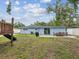 A spacious backyard featuring a grill, patio, and grassy area at 232 Emerald Ln, Largo, FL 33771