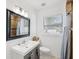 Bright bathroom features a modern vanity, framed mirror and shower-tub combination at 232 Emerald Ln, Largo, FL 33771