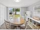 Bright dining area features sliding glass doors to the backyard and a modern shelving unit at 232 Emerald Ln, Largo, FL 33771