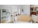 Open dining area featuring a hardwood table, shelving, and a view of the kitchen sink at 232 Emerald Ln, Largo, FL 33771