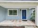 Inviting entryway featuring a blue front door, tile flooring, and a classic window at 232 Emerald Ln, Largo, FL 33771
