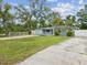 Charming single-story home featuring a well-maintained lawn and tasteful landscaping with mature trees at 232 Emerald Ln, Largo, FL 33771
