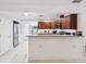 Bright kitchen showcasing granite countertops, stainless steel fridge and bar seating at 232 Emerald Ln, Largo, FL 33771