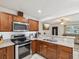 Modern kitchen with wooden cabinets, stainless steel appliances, and open design at 232 Emerald Ln, Largo, FL 33771