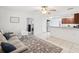Open-concept living room with a comfortable sofa, decorative rug, and access to kitchen at 232 Emerald Ln, Largo, FL 33771