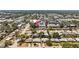 An aerial view of a residential neighborhood with tree-lined streets and nearby commercial areas and a red map pin at 2366 Shelley St # 7, Clearwater, FL 33765