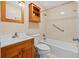 Bright bathroom featuring a shower and tub combination and wood cabinetry at 2366 Shelley St # 7, Clearwater, FL 33765