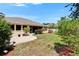 This home features a lush green backyard with a screened-in lanai and a beautiful paver patio for outdoor entertaining at 2515 Centennial Falcon Dr, Valrico, FL 33596