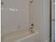 Bathroom featuring tiled shower and tub with neutral walls and fixtures at 2515 Centennial Falcon Dr, Valrico, FL 33596
