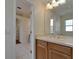 Bathroom vanity with mirror and view into a hallway and other parts of the home at 2515 Centennial Falcon Dr, Valrico, FL 33596