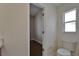 Bathroom with toilet and open closet space, offering practical storage and functionality at 2515 Centennial Falcon Dr, Valrico, FL 33596
