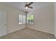 Bedroom featuring white walls, gray carpet, ceiling fan, and shuttered window at 2515 Centennial Falcon Dr, Valrico, FL 33596