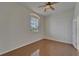 Bright bedroom with hardwood floors, a ceiling fan, and a window with shutters at 2515 Centennial Falcon Dr, Valrico, FL 33596