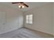 Bedroom features neutral carpet, a ceiling fan, and a shuttered window at 2515 Centennial Falcon Dr, Valrico, FL 33596