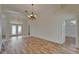 Bright dining room with new wood flooring, chandelier and entry with glass front doors at 2515 Centennial Falcon Dr, Valrico, FL 33596