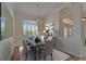 Dining area with shuttered window overlooking backyard with chandelier over dark wood table with seating at 2515 Centennial Falcon Dr, Valrico, FL 33596