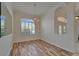 Dining area with shuttered window overlooking backyard, new wood flooring, and chandelier at 2515 Centennial Falcon Dr, Valrico, FL 33596