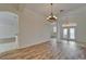Open dining room area with new wood flooring, chandelier and entry with glass front doors at 2515 Centennial Falcon Dr, Valrico, FL 33596