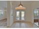 Bright foyer with decorative glass double doors and views into the formal areas at 2515 Centennial Falcon Dr, Valrico, FL 33596