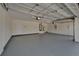Spacious two-car garage with epoxy flooring, clean walls, and overhead lighting at 2515 Centennial Falcon Dr, Valrico, FL 33596