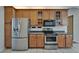 Well-equipped kitchen features stainless steel appliances and wood cabinetry, offering both style and functionality at 2515 Centennial Falcon Dr, Valrico, FL 33596