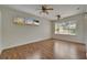 Empty living room featuring wood floors, two ceiling fans, and lots of natural light at 2515 Centennial Falcon Dr, Valrico, FL 33596