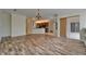 Open-concept living room featuring hardwood floors and a view of the adjacent kitchen at 2515 Centennial Falcon Dr, Valrico, FL 33596