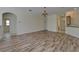 Spacious living area with wood-style flooring, leading into different parts of the home at 2515 Centennial Falcon Dr, Valrico, FL 33596