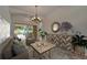 Cozy living room with stylish furniture, a decorative mirror, and a view to the outdoors at 2515 Centennial Falcon Dr, Valrico, FL 33596