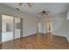 Large living room with glass doors, wood floors, and an arched entry to another room at 2515 Centennial Falcon Dr, Valrico, FL 33596