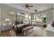 Staged main bedroom with a four-poster bed, bench, and lots of natural light at 2515 Centennial Falcon Dr, Valrico, FL 33596