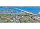 Scenic aerial view showcases waterfront homes, lush trees, and a beautiful bridge spanning the expansive blue waters at 2525 W Bay Dr # A20, Belleair Bluffs, FL 33770