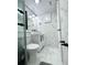 Stylish bathroom features a glass shower, marble walls, modern vanity, and sleek black hardware at 2525 W Bay Dr # A20, Belleair Bluffs, FL 33770