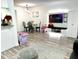 Living area boasts modern lighting, sleek entertainment center, and open space into the dining area at 2525 W Bay Dr # A20, Belleair Bluffs, FL 33770